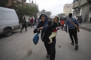 Palestinians evacuate from a site hit by an Israeli bombardment on Rafah, southern Gaza Strip, Wednesday, Dec. 20, 2023.