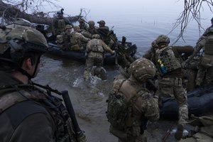 FILE - Ukrainian servicemen board a boat on the shore of Dnieper River near Kherson, Ukraine, Sunday Oct. 15, 2023. After blunting Ukraine's counteroffensive from the summer, Russia is building up its resources for a new stage of the war over the winter, which could involve trying to extend its gains in the east and deal significant blows to the country's vital infrastructure. Russia has ramped up its pressure on Ukrainian forces on several parts of the more than 1,000-kilometer (620-mile) front line.