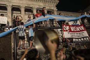 Protesters chant anti-government slogans while gathering outside the National Congress during a protest against government economic measures in Buenos Aires, Argentina, Thursday, Dec. 21, 2023. Days after taking office, Argentine President Javier Milei's government announced drastic economic measures that angered some social and labor groups, and warned it would crack down on any protests blocking streets.