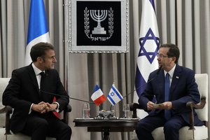 French President Emmanuel Macron, left, meets Israel's President Isaac Herzog in Jerusalem, Tuesday, Oct. 24, 2023