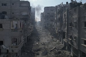 Rubble litters a street between smoldering buildings hit by an Israeli airstrike in Jabaliya, Gaza Strip, Wednesday, Oct. 11, 2023.