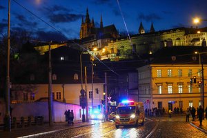 An ambulance drives towards the building housing the Philosophical Faculty of Charles University in downtown Prague, Czech Republic, Thursday, Dec. 21, 2023. Czech police say a shooting in downtown Prague has killed an unspecified number of people and wounded others.