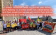 dozens of RMT union members outside Temple Meads train station, they have flags and banners. Above them on the text has been added "i always remember what my mother used to say ,we're fighting for a better world not just for better pay, and if we stand together we will win this fight in time, as long as don't walk across each others picket lines