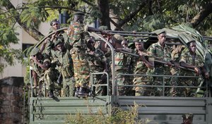 Soldiers loyal to Burundian President Pierre Nkurunziza control the offices of the national radio and television station, in the capital Bujumbura, Burundi, Friday, May 15, 2015.