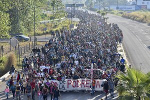 Migrants depart from Tapachula, Mexico, Sunday, Dec. 24, 2023.