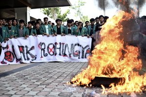 Protesters burn tires during a protest rejecting Rohingya refugees in Banda Aceh, Aceh province, Indonesia, Wednesday, Dec. 27, 2023.