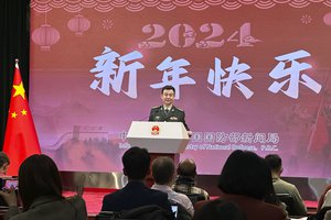 China's Defense Ministry spokesperson Col. Wu Qian speaks to reporters at a monthly briefing in Beijing, Thursday, Dec. 28, 2023