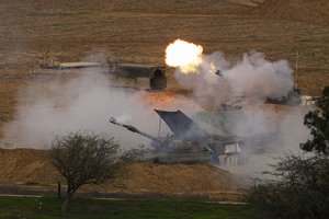 An Israeli mobile artillery unit fires a shell from southern Israel towards the Gaza Strip, in a position near the Israel-Gaza border on Thursday, Dec. 28, 2023