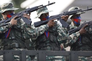 Soldiers aim their weapons aboard a truck during the military parade marking the 200th anniversary of the battle of Carabobo in Valencia, Carabobo state, Venezuela, Thursday, June 24, 2021