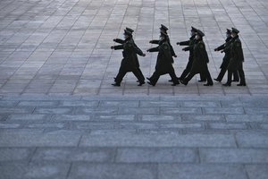 Soldiers wearing face masks march outside the Great Hall of the People in Beijing, Friday, March 3, 2023.