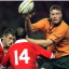 SYD02:SPORT-RUGBY UNION WALES:SYDNEY,22JUN96 - Australia’s Garrick Morgan (R) passes the ball to a teammate as Welsh players Wayne Proctor (L) and Ieuan Evans  come in for the tackle during the second rugby union test in Sydney June 22.  Australia defeated Wales 42-3 to win the two test series two nil.     mb/Photo by Mark Baker    REUTERS