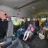 Volunteer Frank Schrever with a bus full of passengers at Sandy Point.
