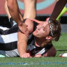 Teammates check on Nathan Murphy before he was subbed off in the grand final.