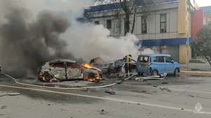 In this photo taken from video released by Russia Emergency Situations Ministry telegram channel on Saturday, Dec. 30, 2023, firefighters extinguish burning cars after shelling in Belgorod, Russia. Russian officials have accused Ukrainian forces of shelling the Russian border city of Belgorod. Two children were killed in Saturday's attack, regional governor Vyacheslav Gladkov said in a statement on social media. He also said that an unspecified number of people had been injured.