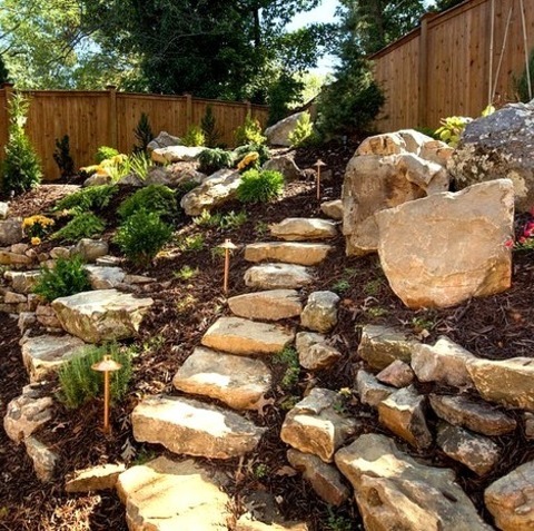 Landscape Natural Stone Pavers
A picture of a sizable, rustic backyard with a stone retaining wall landscape.