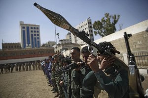 Houthi rebel fighters display their weapons during a gathering aimed at mobilizing more fighters for the Iranian-backed Houthi movement, in Sanaa, Yemen, Thursday, Feb. 20, 2020.