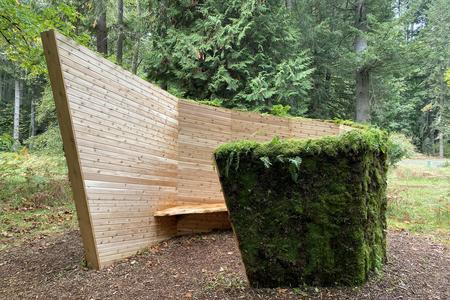 Angular wood and mossy rock outdoor sculpture 