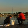 Mucahit Sasmaz (left) and Murat Zengin enjoy an early morning fish down by Rozelle Bay.