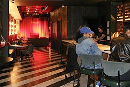 Patrons socialize during happy hour at Nostalgia Wine & Jazz Lounge.