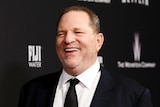 Weinstein laughs on the red carpet of the Golden Globes after party in 2014.