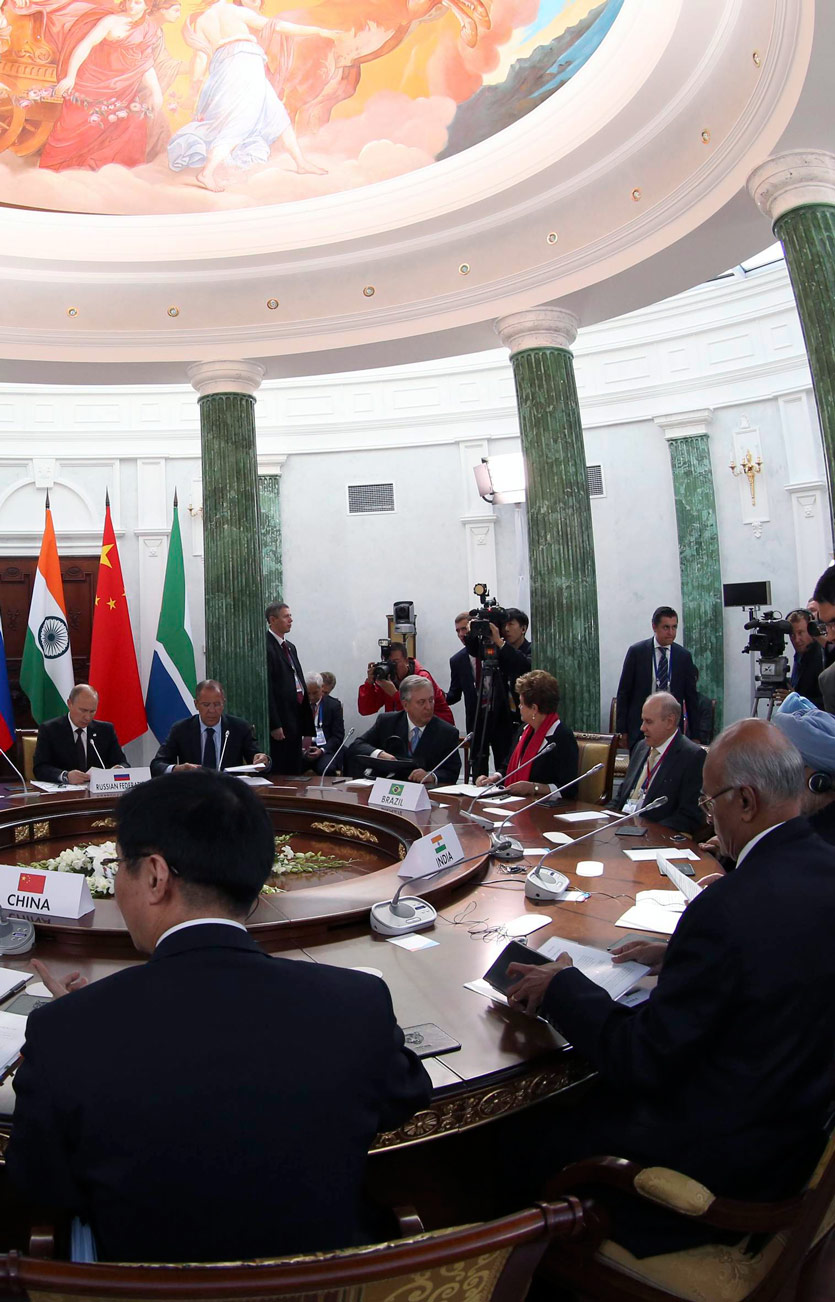 large conference table at which world leaders are seated, surrounded by press and their minions, a summitt meeting with greek columns of marble and a traditional fresco in the dome above