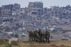 Israeli female soldiers pose for a photo on a position on the Gaza Strip border, in southern Israel, Monday, Feb. 19, 2024.