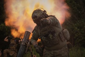 A Ukrainian soldier gestures as he fires toward Russian position on the frontline in Zaporizhzhia region, Ukraine, Saturday, June 24, 2023