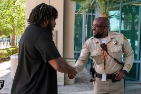 Las Vegas Raiders guard Dylan Parham meets Las Vegas Metropolitan Police Department Lieutenant Kendall Bell. 