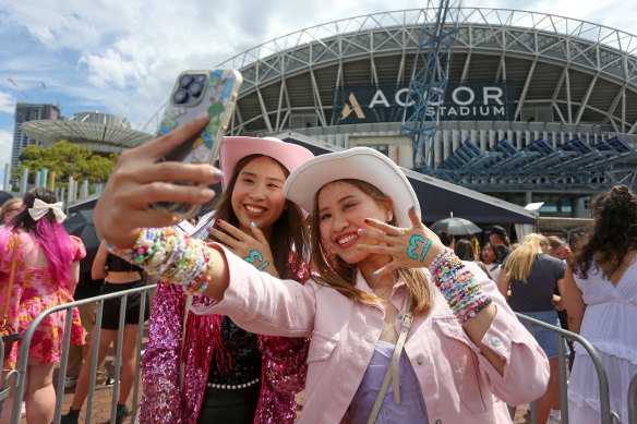 Taylor Swift fans snap a selfie outside Accor Stadium.