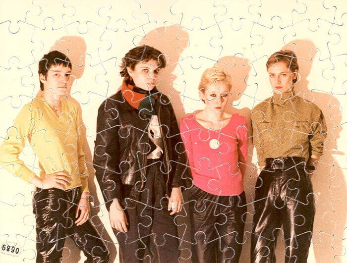 The four women of the Swiss band Kleenex appear against a wall.