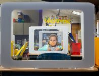 A second-grade student works behind a protection shield at a socially distanced desk at Wesley Elementary School.