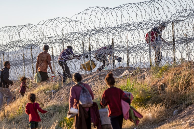 Migrants cross into the United States from Mexico in El Paso, Texas, on May 8, 2023.