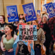 Protesters stand outside of the Senate chamber at the Indiana Statehouse