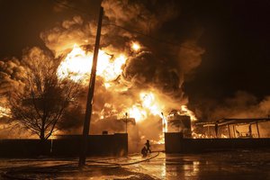 Firefighters extinguish a blaze after an attack on a residential neighborhood in Kharkiv, Ukraine, Saturday, Feb. 10, 2024. The second year of Ukraine’s fight against Russia’s full-scale invasion brought no respite for Ukrainian soldiers or civilians. Associated Press photographers documented the past 12 months of death and destruction, agony and grief — as well as the glimpses of joy — that are staples of life during war.