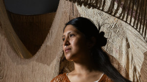 Peruvian artist Cristina Flores Pescorán with her woven sculpture at White Bay Power Station.