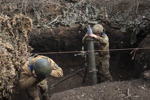 Ukrainian servicemen of the 28th Separate Mechanised Brigade fires a 122mm mortar towards Russian positions at the front line, near Bakhmut, Donetsk region, Ukraine, Sunday, March 3, 2024.