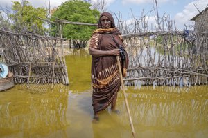 File - Abdia Sheikh Abdullahi, 70-years-old, stands in the water by her flooded house in Mandera County, Kenya, Wednesday, Dec. 13, 2023. Rains began pounding the country in October. At the end of November Kenya President William Ruto convened an emergency cabinet meeting saying 38 of Kenya’s 47 counties had been affected by floods and mudslides made worse by the El Niño phenomenon.