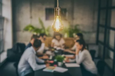 people seated around a conference table working