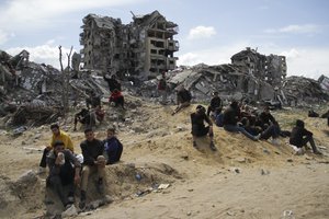 Palestinians wait for the humanitarian aid to be dropped by the U.S. Air Force in Gaza City, Gaza Strip, on Saturday, March 9, 2024.