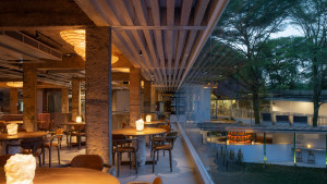 The first-floor dining room of AIR is lit by paper and recycled plastic lanterns and has views across the lawn and garden.