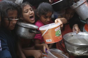 File - Palestinians line up for food during the ongoing Israeli bombardment of the Gaza Strip in Rafah on Monday, November 13, 2023.