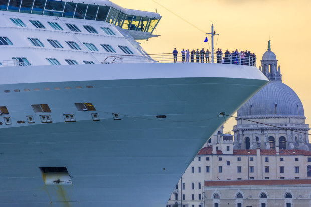 <p>Venice Italy on October 09, 2013: Cruise ship leaving Venice harbor at the end of the day</p>
