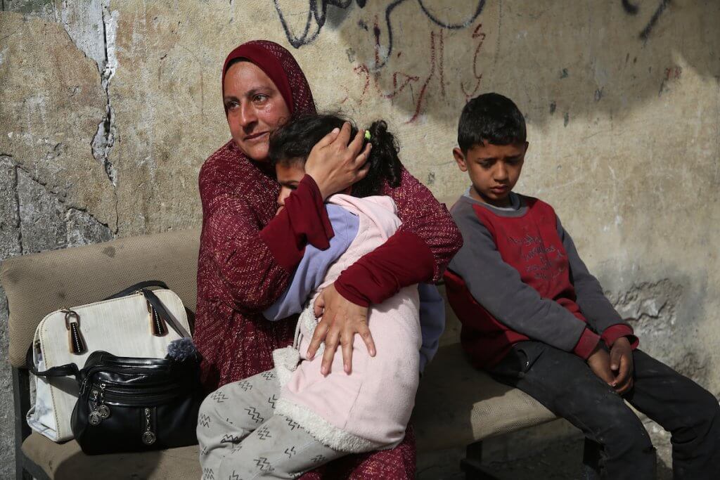 Palestinians outside a building belonging to the Dhaheer family that was destroyed by an Israeli attack in Rafah on March 27, 2024. (Photo: Stringer/ APA Images)