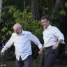 Brazilian President Luiz Inacio Lula da Silva, left, and French President Emmanuel Macron arrive on Combu Island, Para state, Brazil, on Tuesday. The image was co-opted by memes poking fun at their “very close” relationship.