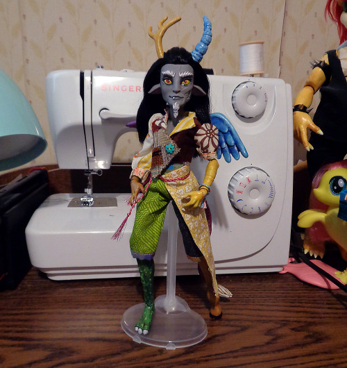 A custom monster high doll, made to look like gijinka of Discord from My little Pony. He is wearing a patchwork outfit.