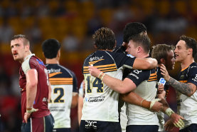 The ACT Brumbies celebrate Saturday’s win over Queensland.