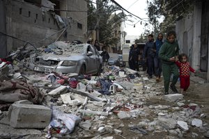 Palestinians look at the destruction after an Israeli airstrike in Rafah, Gaza SAtrip, Friday, Feb. 9, 2024.