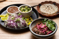 The go-to dish: falling-apart lamb barbacoa served with warm flour tortillas.