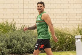 Latrell Mitchell heads into South Sydney training on Tuesday all smiles.