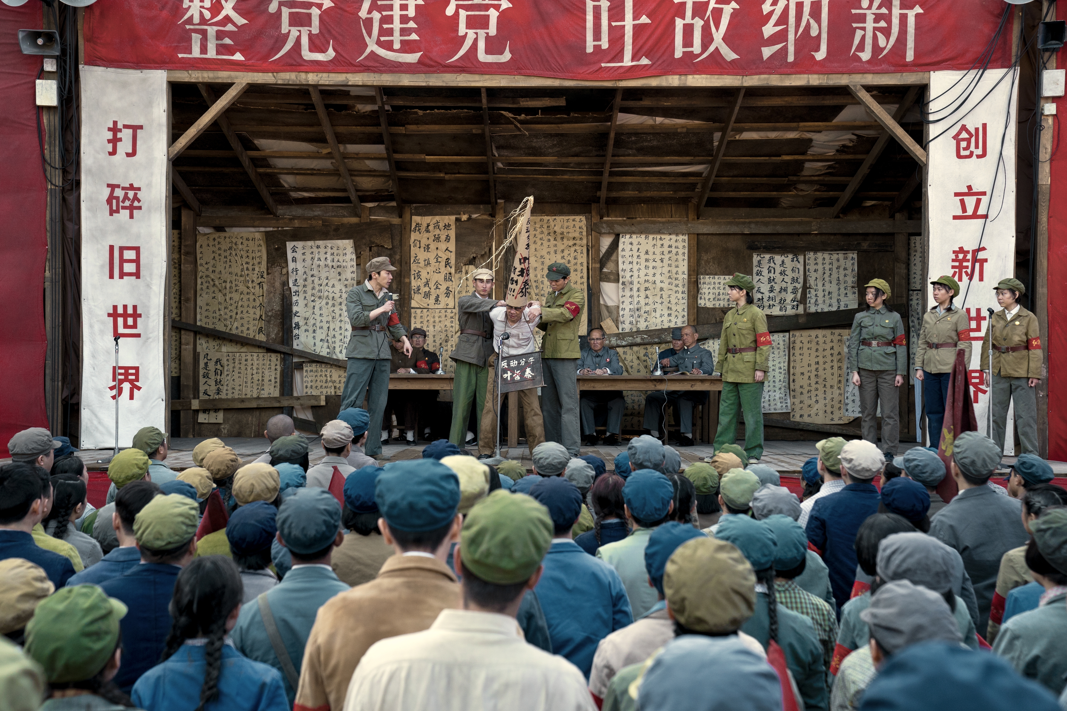 People watching an outdoor stage performance.